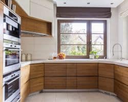 Wooden cupboards and white worktops in new kitchen with Roman Blinds Roman Blinds in new kitchen